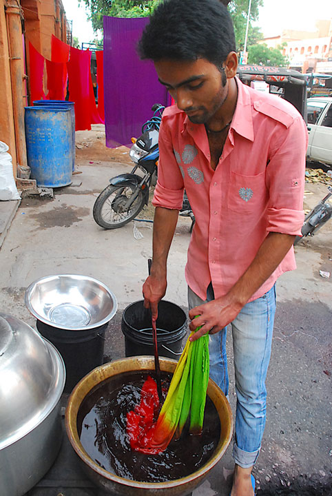 man dying cloth in a bucket