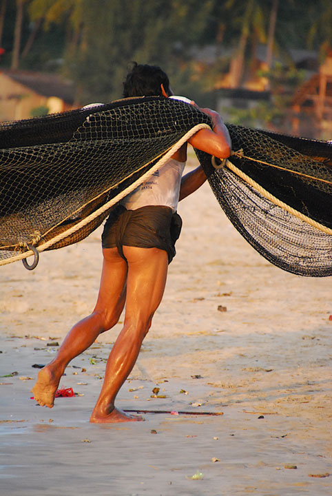 man carrying giant net over his shoulder