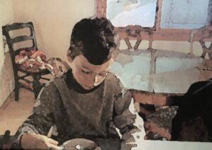 Child at counter looking down at a bowl