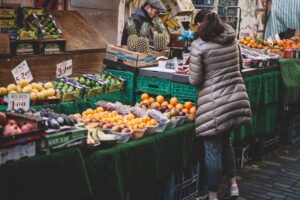 Fruit market with woman making selection