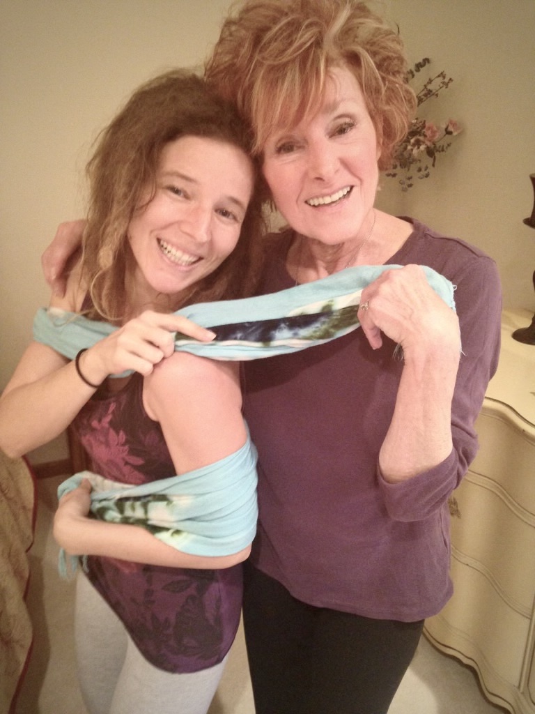 Grandmother with Arm Around Granddaughter who is wrapped in a blue shawl