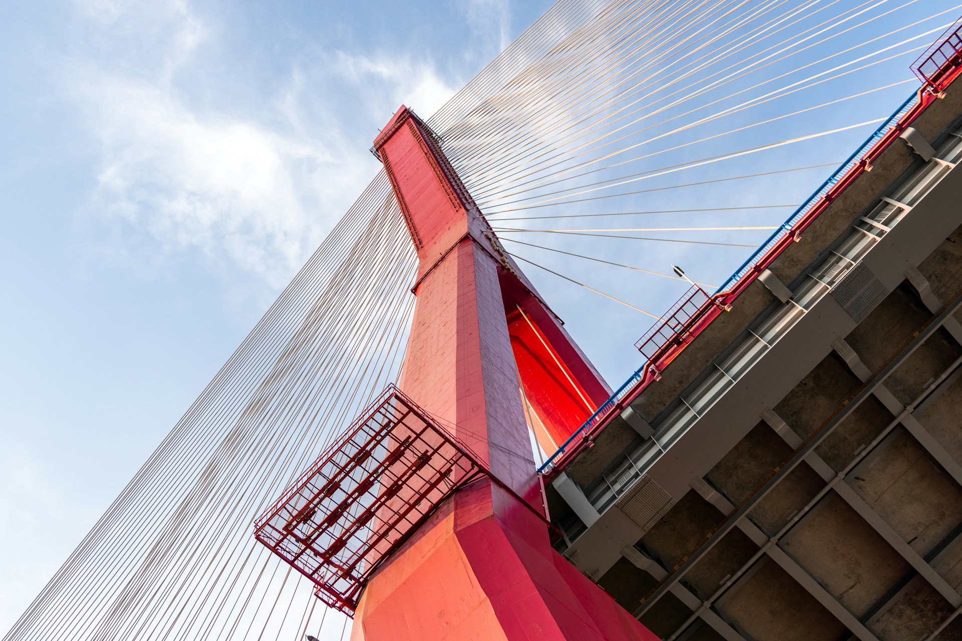 Looking Up from Under a Red Tower of a Suspension Bridge

