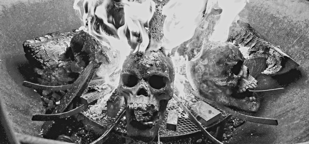 Skull enflamed in a fire pit captured in gray scale