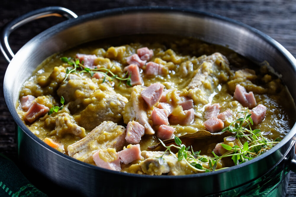Photo of a pot of split pea soup cooking on the stove.